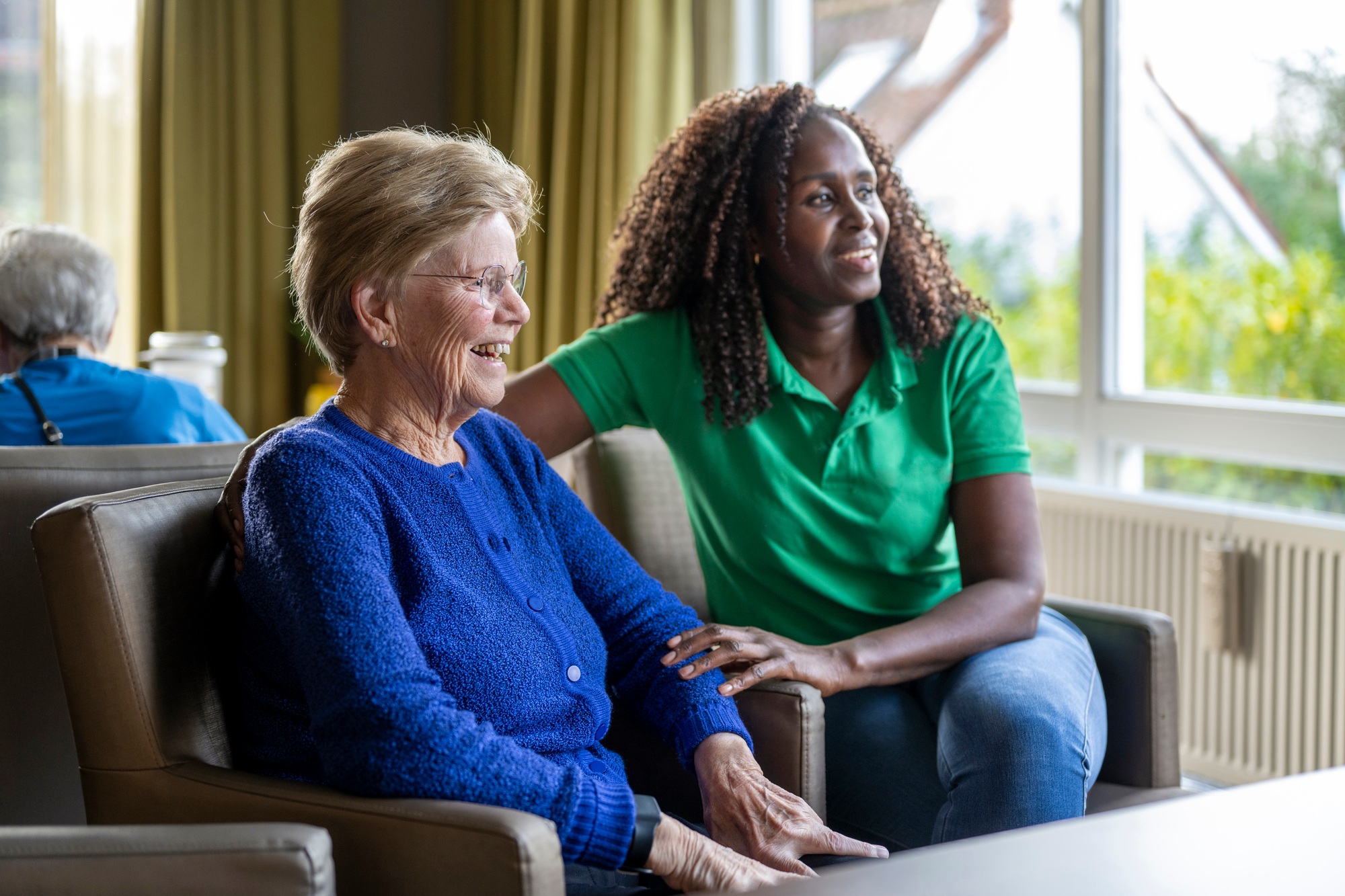 Helper caring for elderly lady