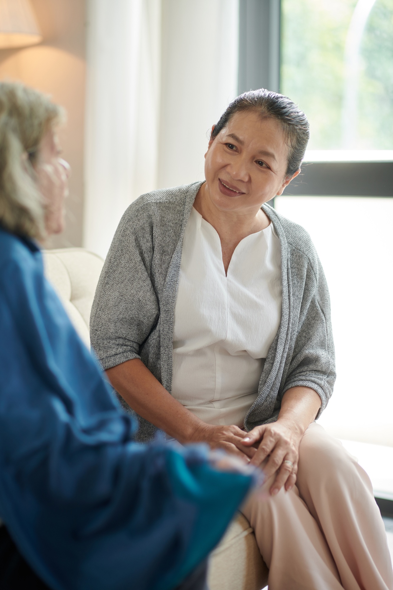Elderly Woman Listening to Friend